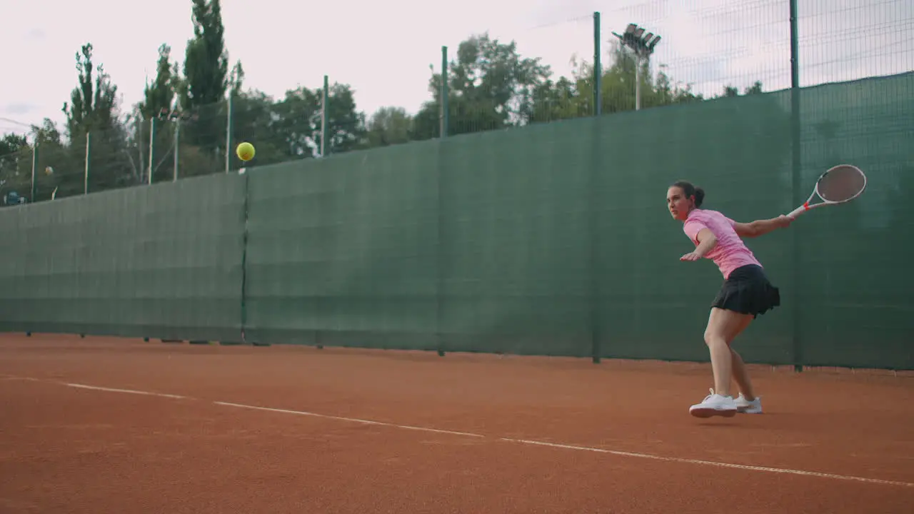 Young female tennis player concentrating and focusing on her forehand game Professional equipped female beating hard the tennis ball with tennis racquet