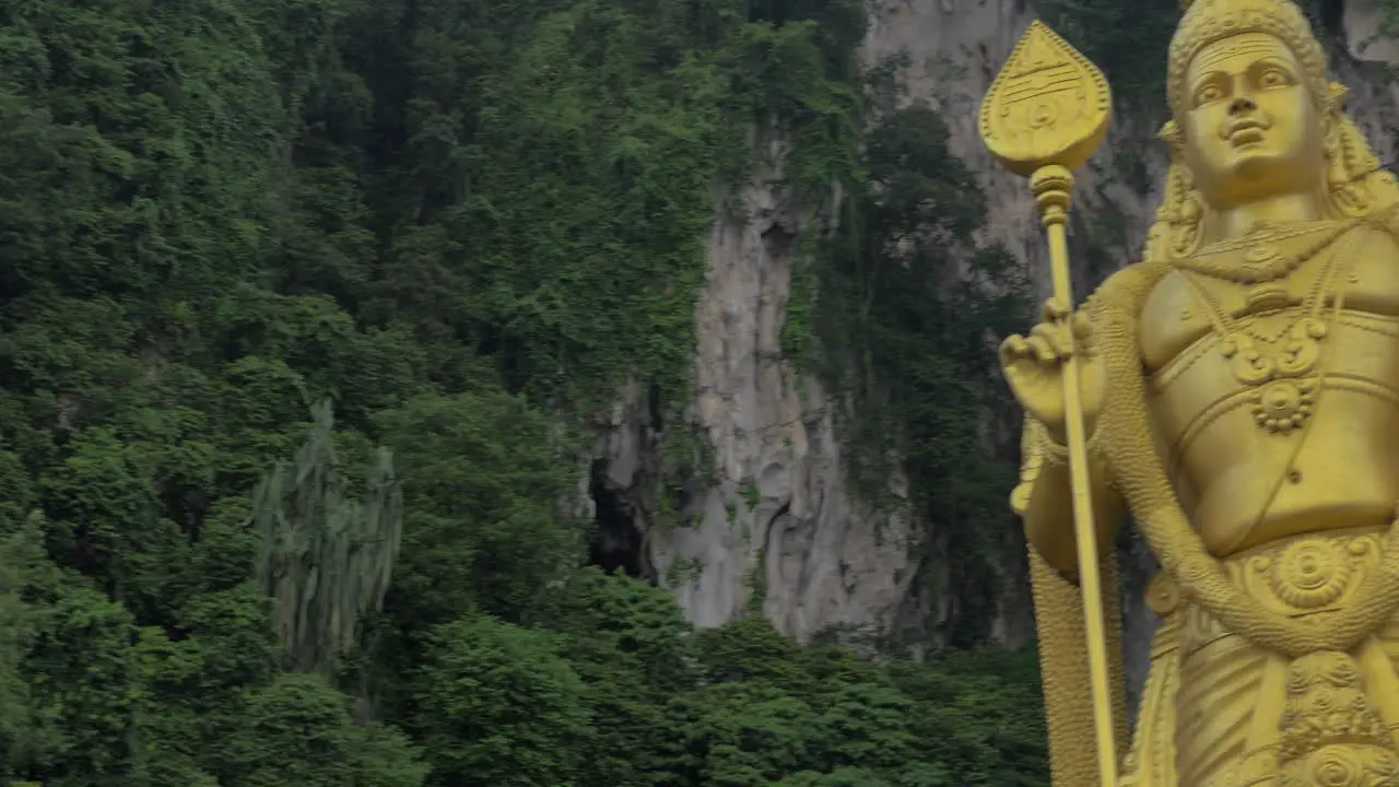 Seen green mountains and statue of Murugan at Batu Caves