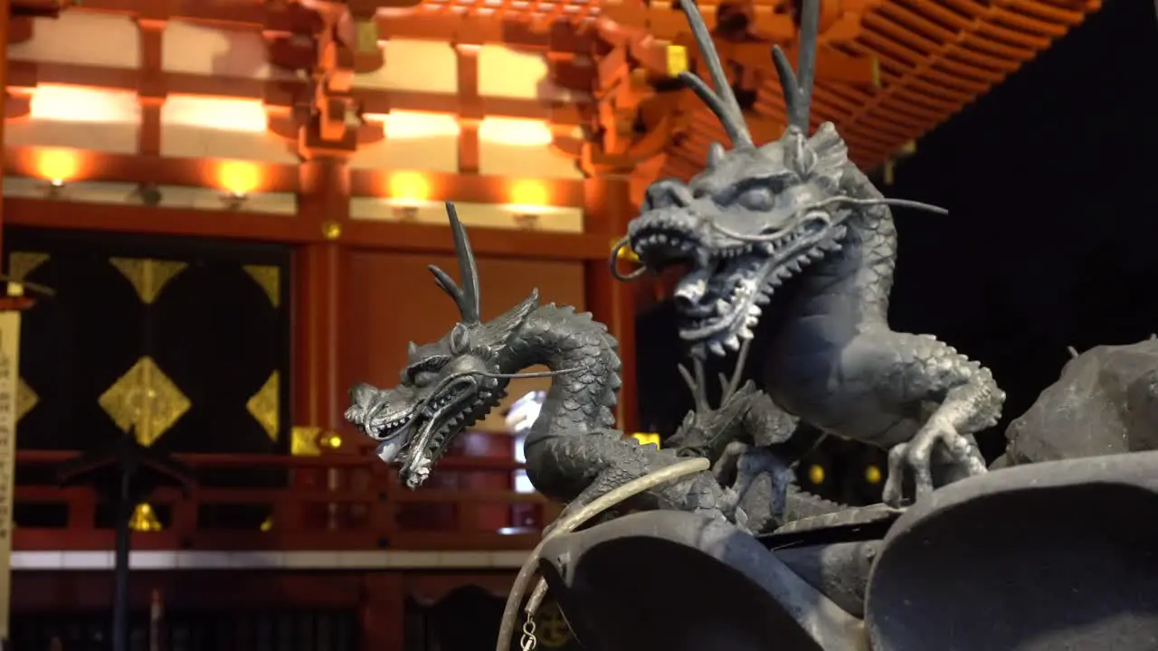 Little Iron Dragons infront of illuminated Asakusa Shinto Shrine Temple Senso-Ji in the night a famous tourist attraction in Japan Tokyo