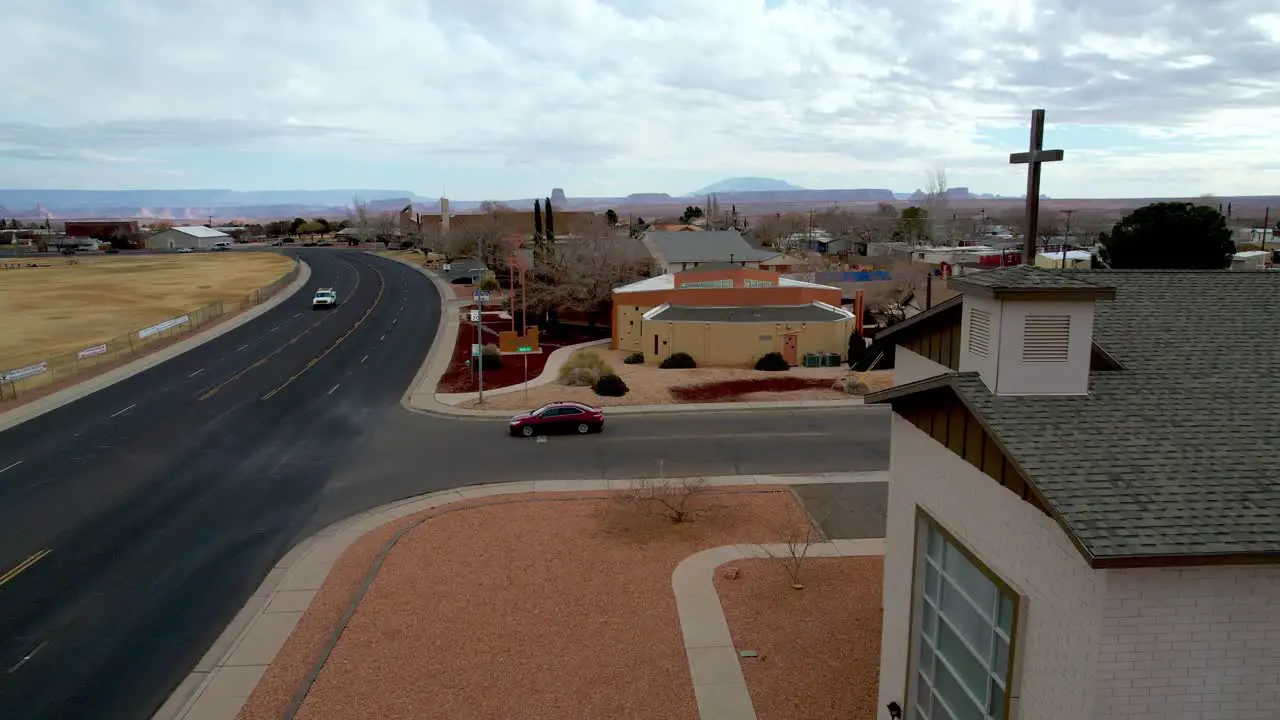 Aerial passing cross atop church in Page Arizona