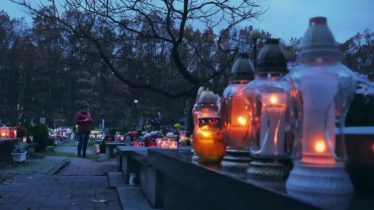 Woman standing in a cmetery at the evening