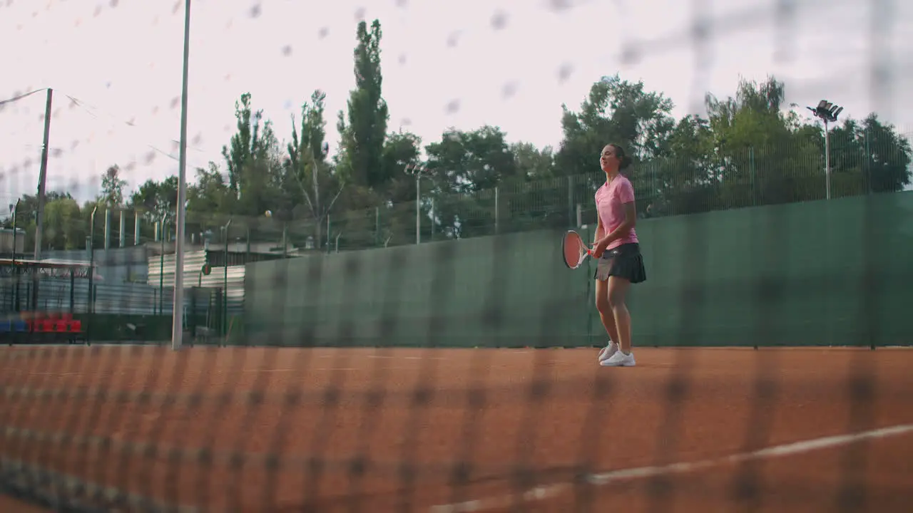 slow motion female tennis player hitting the ball during a game