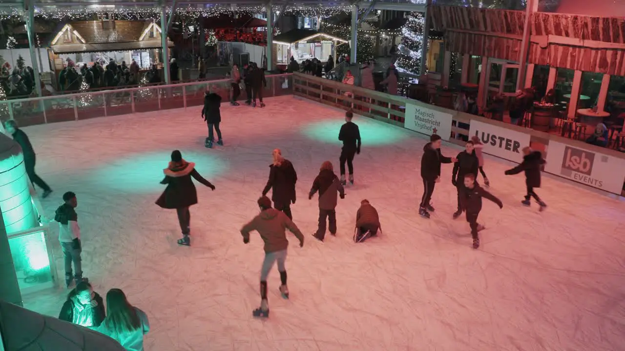 top view of people ice stating kids playing on ice at Christmas market in Maastricht in The Netherlands