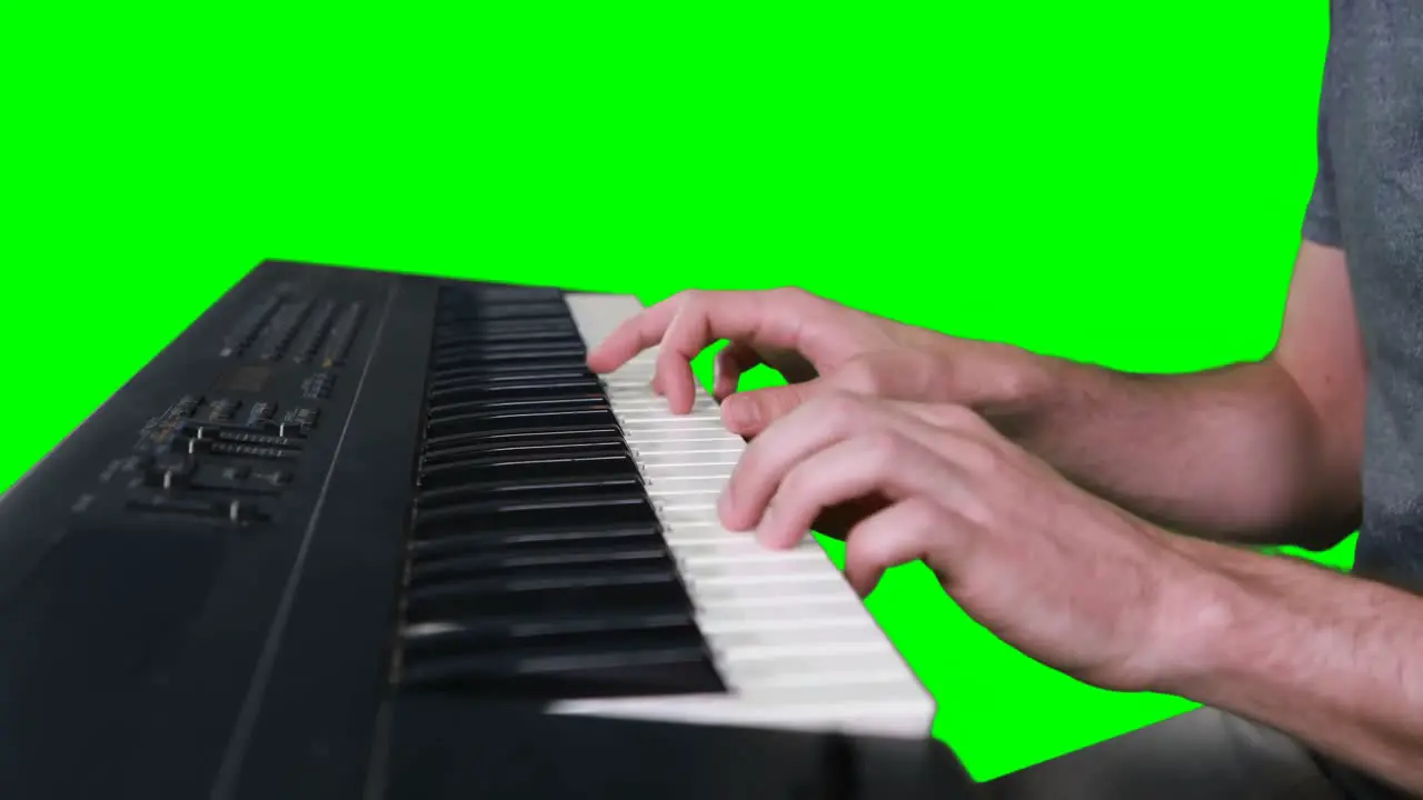 Mid section of musician playing electronic piano