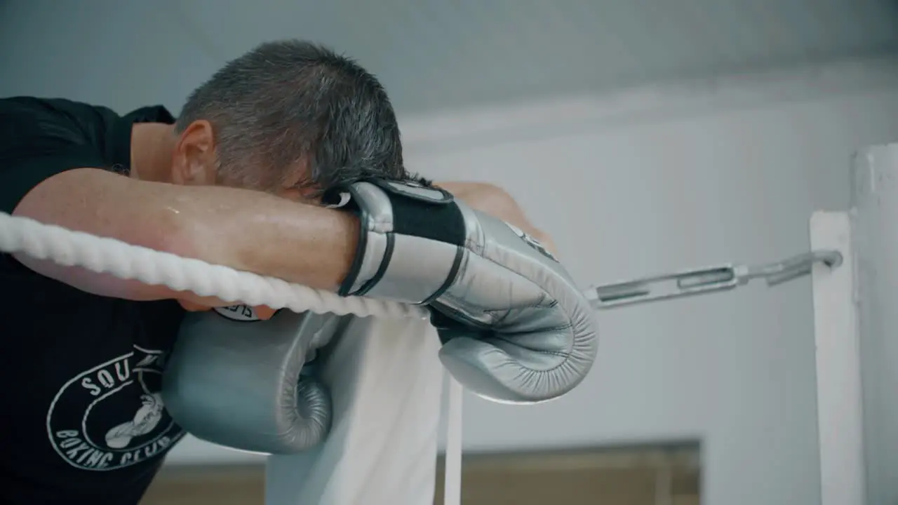 Tired Boxer in Corner of Ring