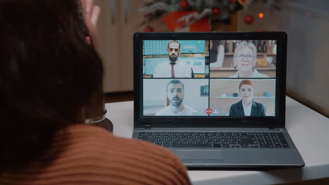 Young adult talking on video call with friends at home