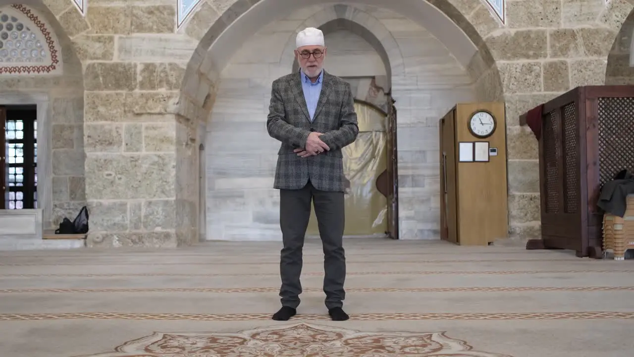 Old man praying in mosque