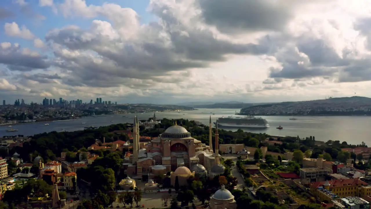 An awe-inspiring encounter between artistry and nature Istanbul's Blue Mosque amidst sunset's radiance embraced by immense billowing clouds