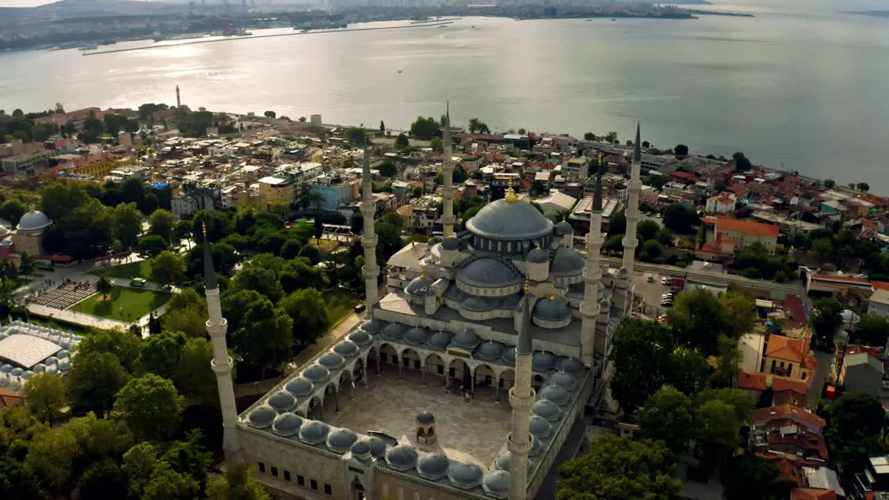 Experience Istanbul's magical transition from day to night as a drone unveils the enchanting Blue Mosque under the warm embrace of a setting sun