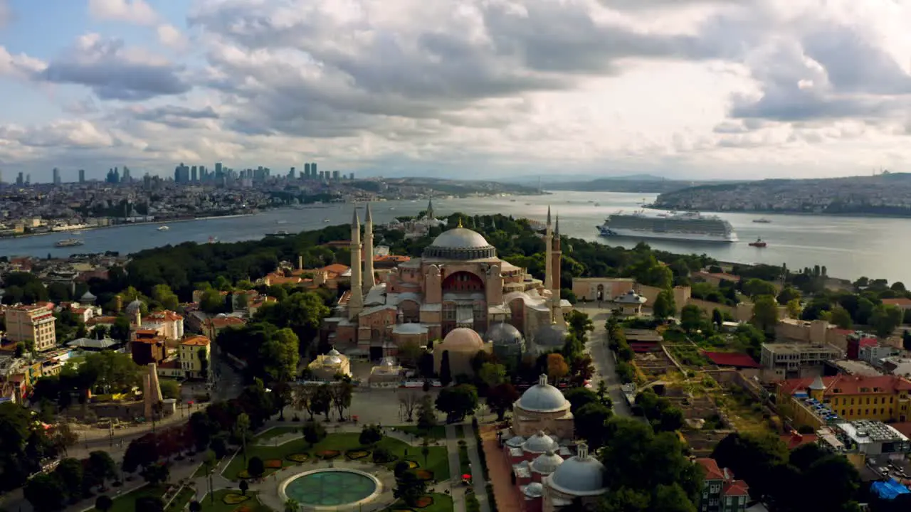 A cinematic spectacle Istanbul's Blue Mosque beneath a fiery sunset sky framed by colossal clouds in breathtaking aerial drone views