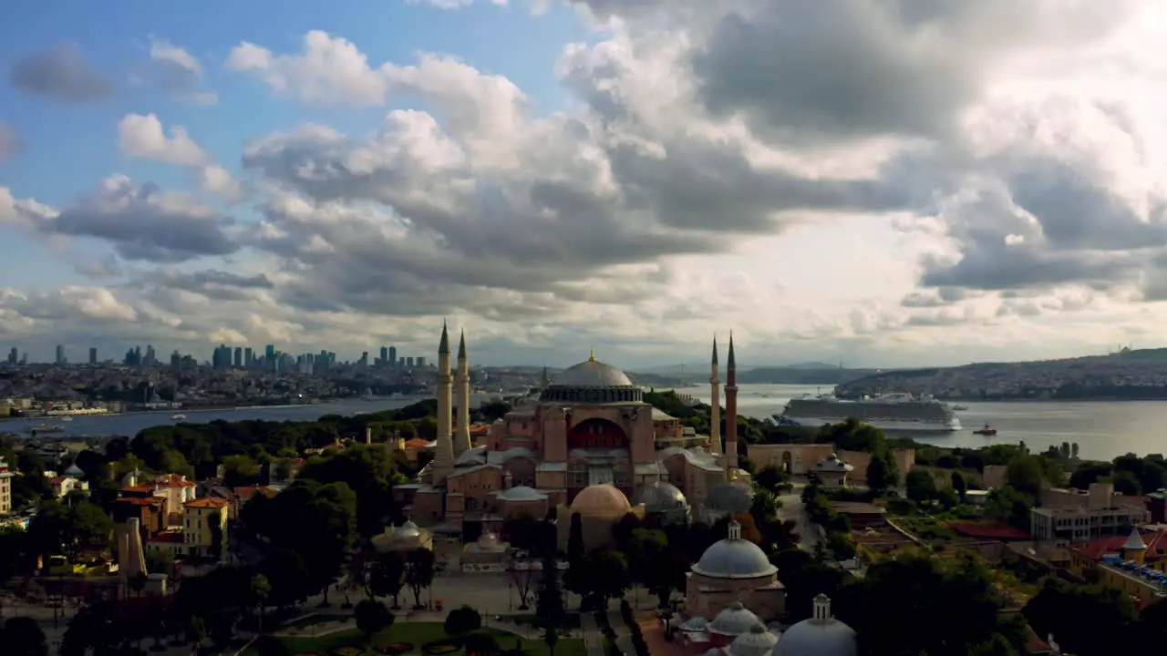 Dramatic aesthetics Istanbul's Blue Mosque at sunset with towering clouds casting a spellbinding aura over the city's architectural masterpiece