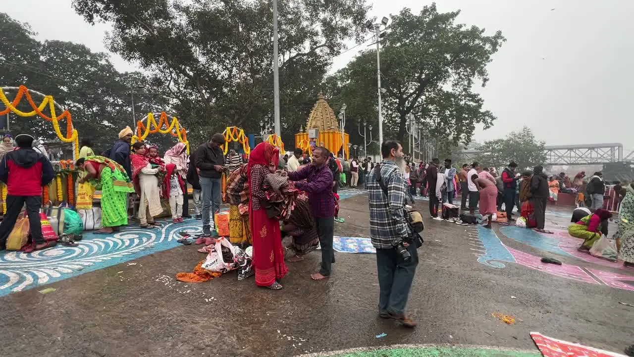 Side view of people packing up after taking bath in Hooghly river at Babu Ghat during Sankranti during Sankranti festival in Kolkata