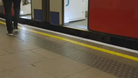 Close Up Of Tube Train Arriving At Platform Of Underground Station In London UK With Passengers Getting Off 1