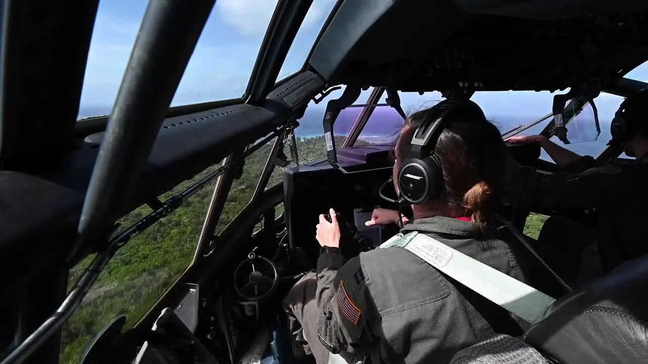 Cockpit Footage Us Air Force Pilots Land A C-130 Hercules Airplane On A Tree Lined Runway In Angaur Palau Guam