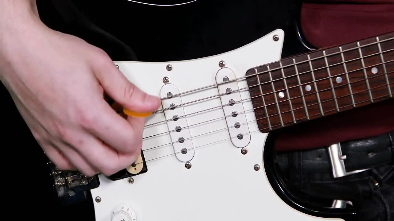 Mid-section of male musician playing guitar