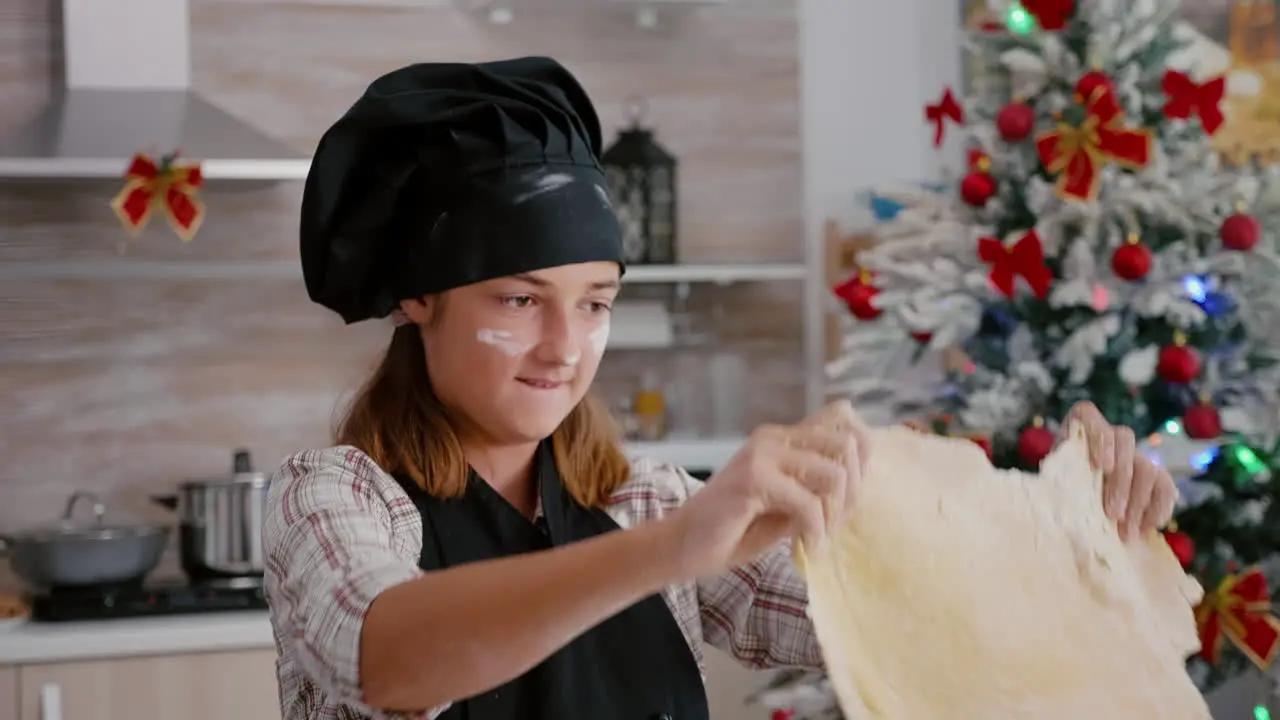 Portrait of children wearing cook apron while standing at table in culinary kitchen