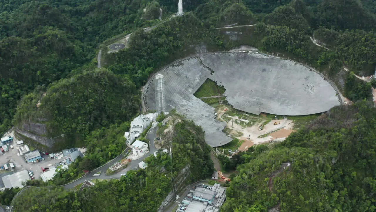 Dolly out shows ongoing deconstruction of parabolic antenna dish at Arecibo Observatory Puerto Rico