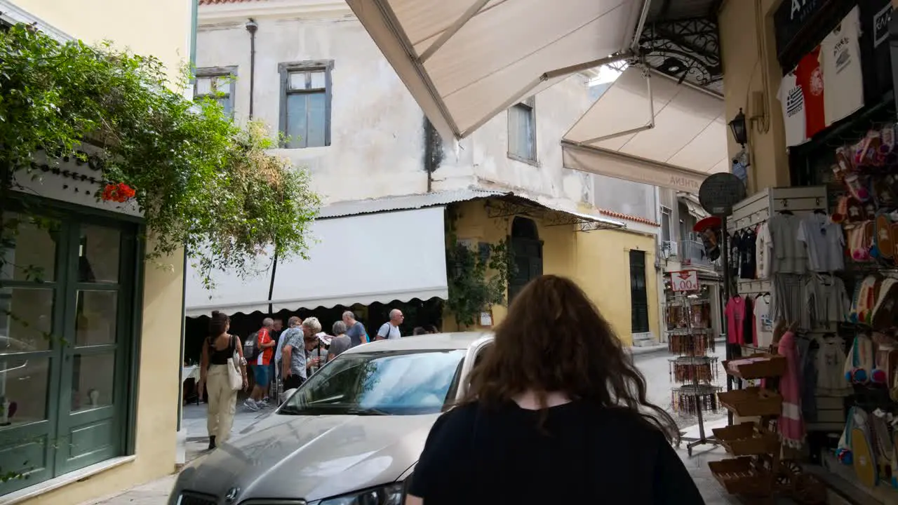 treet Cafe Old town People seated walking ouside in alley at Plaka district