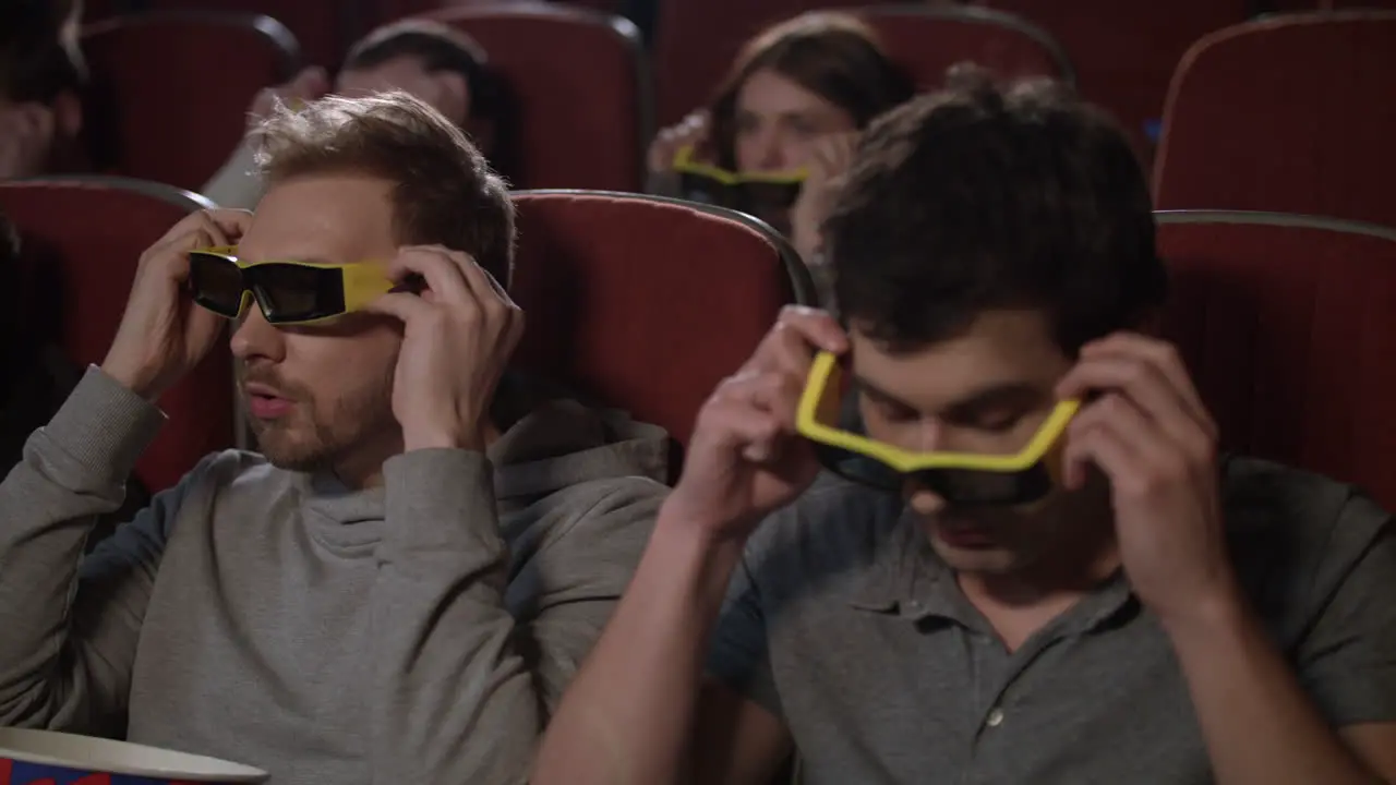 Male friends wearing 3d glasses in the cinema