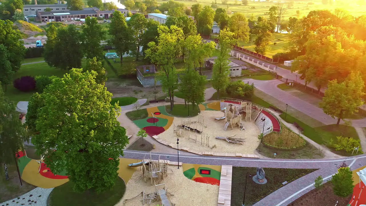 aerial view of a kids park with lots of activities and rides situated in the city