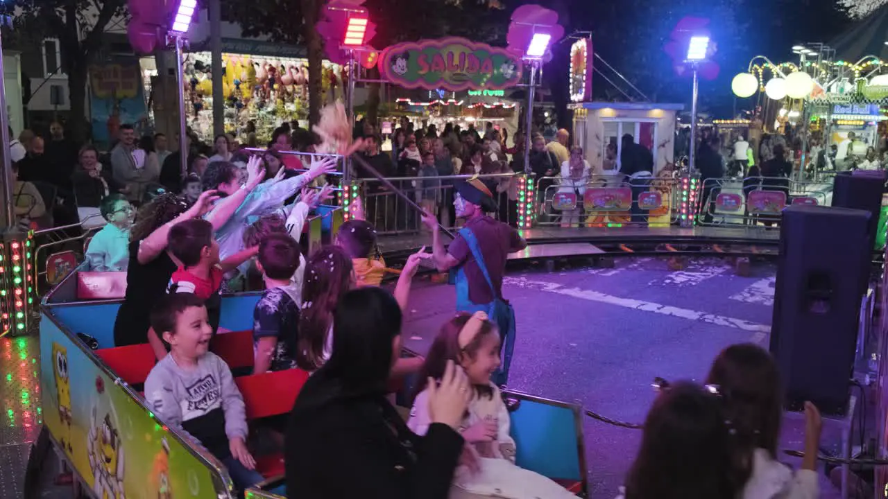 San Froilán Carnival at nighttime people having fun riding Toy train Playground Lugo City Spain