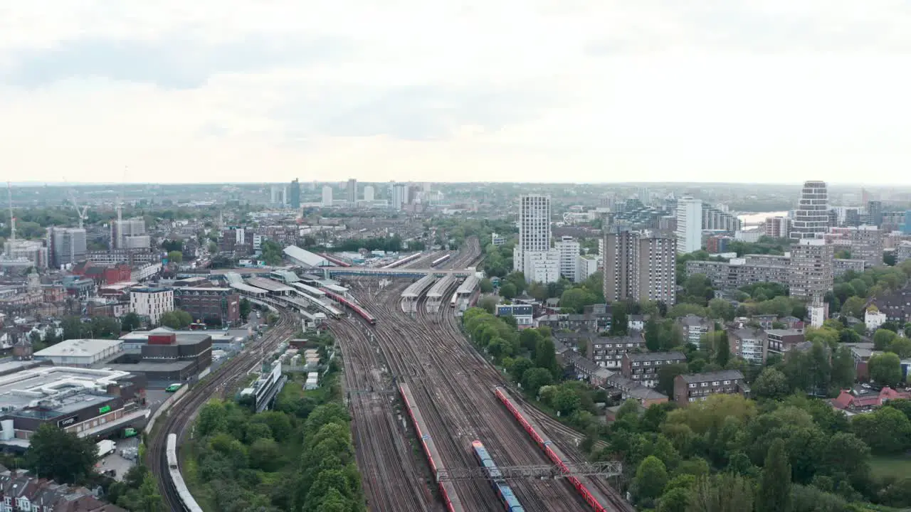 slow dolly forward drone shot of busy London Clapham Junction train station