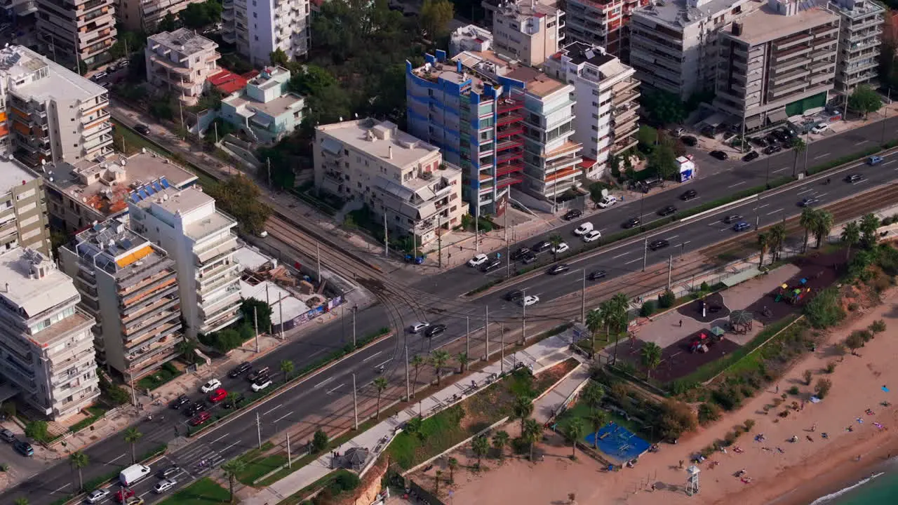 Circling aerial shot of a tram approaching a road junction