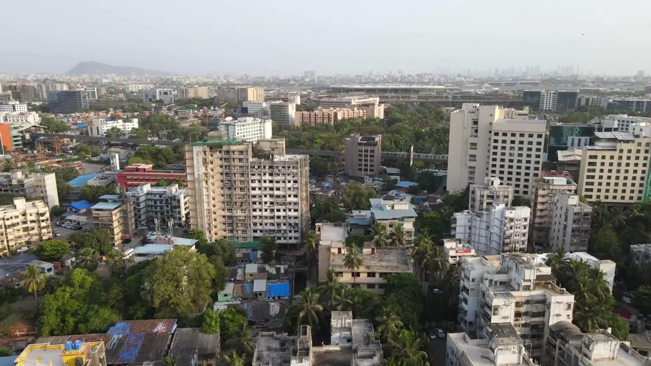 drone shot birds-eye view andheri marol metro station train side view Mumbai India wide angle green city