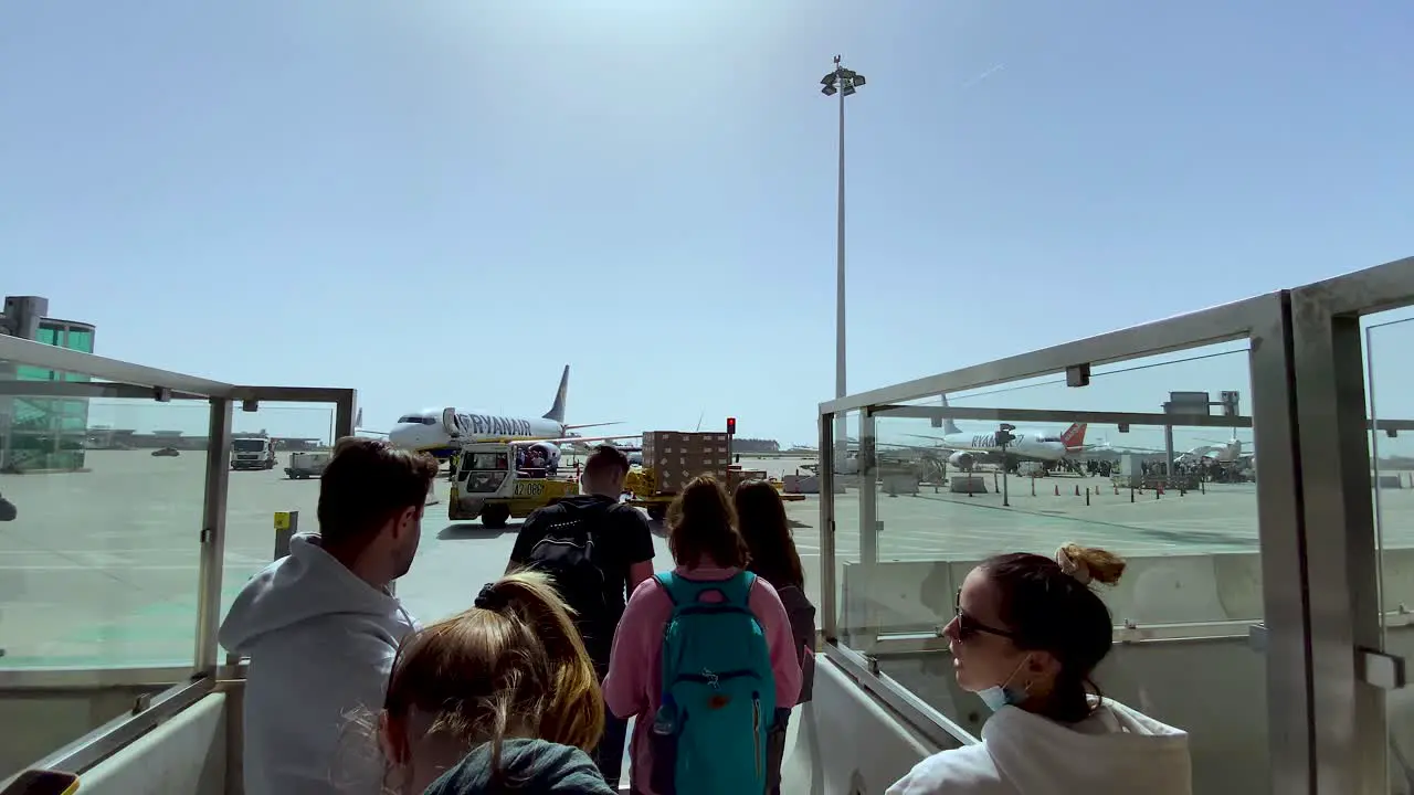 People wait to walk the airport apron to the cruise plane Porto Airport