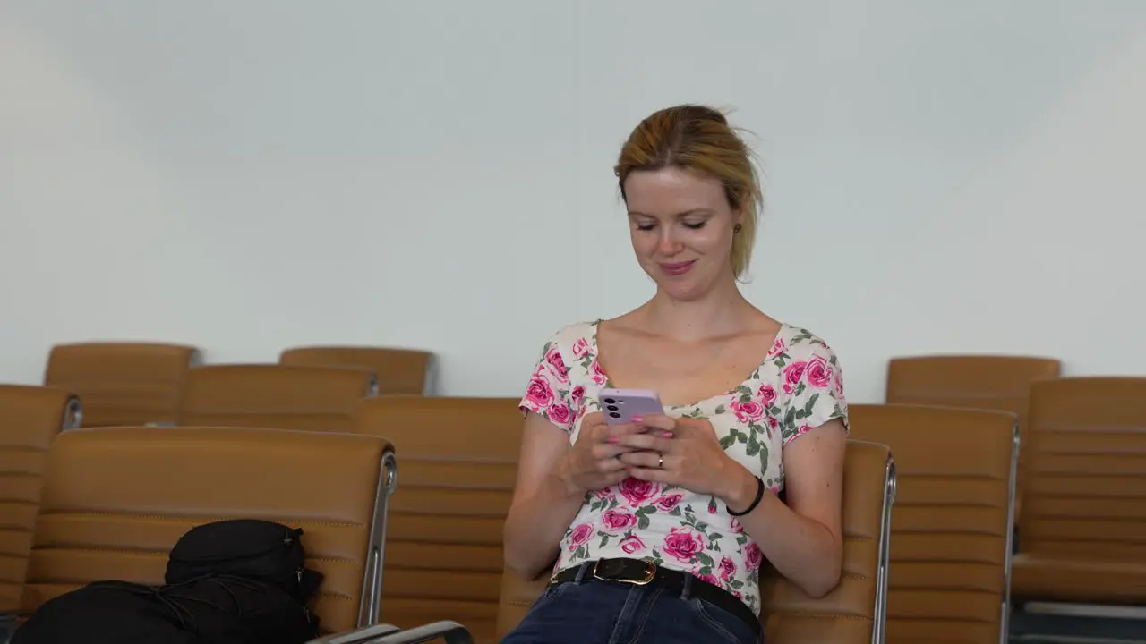 Young woman using a smartphone while waiting at the airport