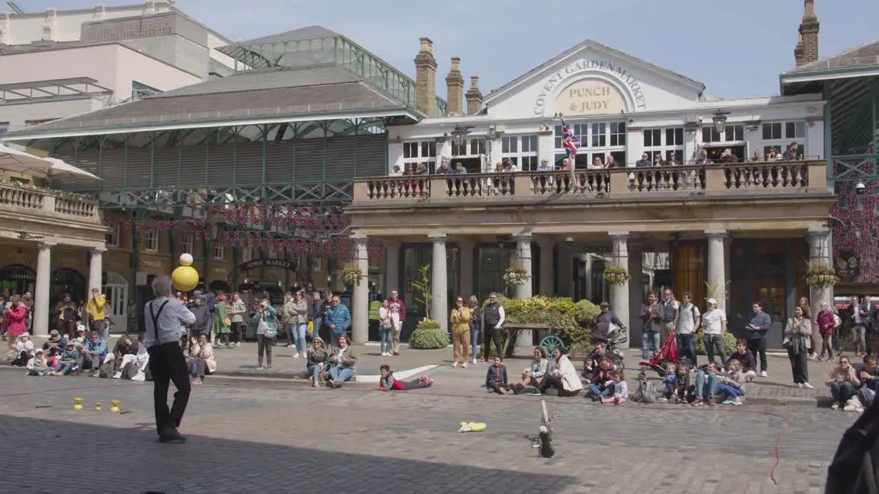 Street Performer In Covent Garden Market With Tourists In London UK 2