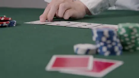 Pull Focus Shot of Poker Dealer Dealing Turn Card