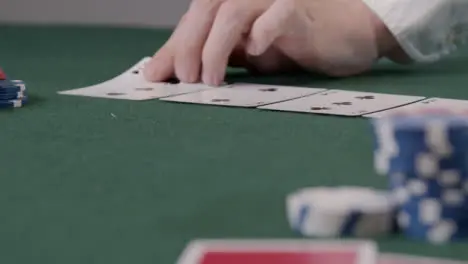 Pull Focus Shot of a Poker Dealer Dealing Turn Card