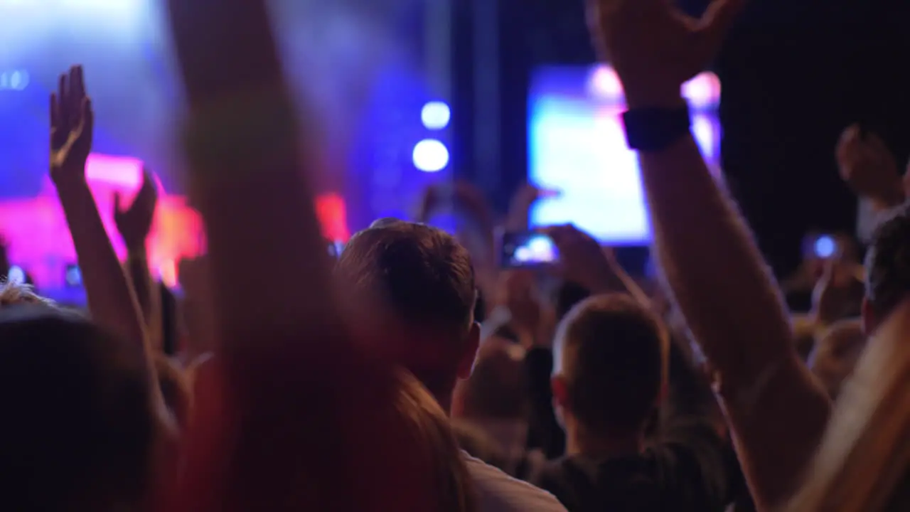 Audience at the concert giving applause to favourite music band