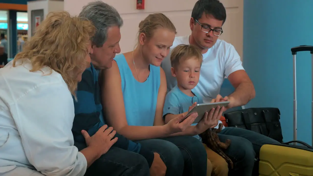 Family with tablet pc computer in the airport