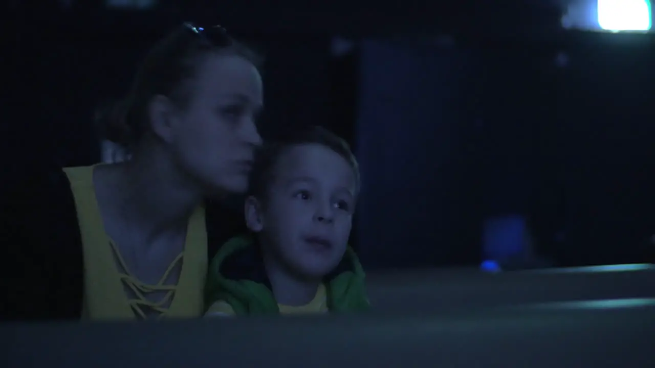 Mom and kid spending leisure at the cinema