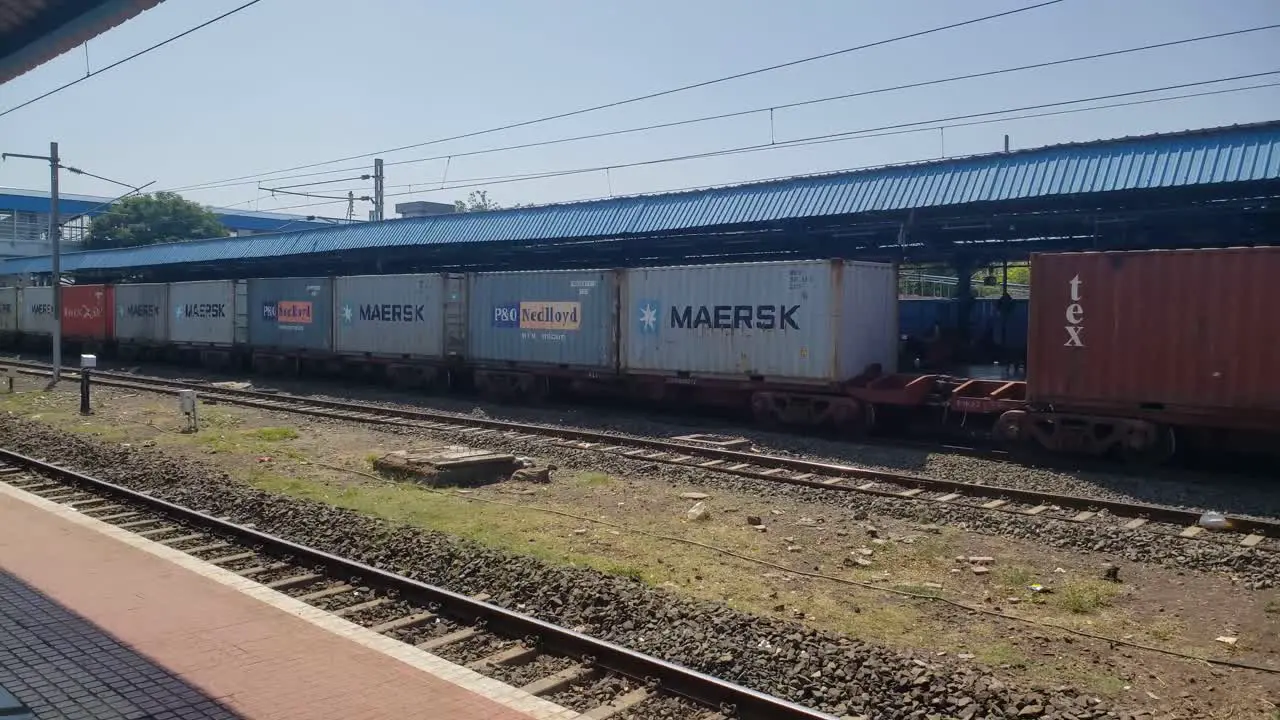 Train wagons carrying cargo containers for shipping companies