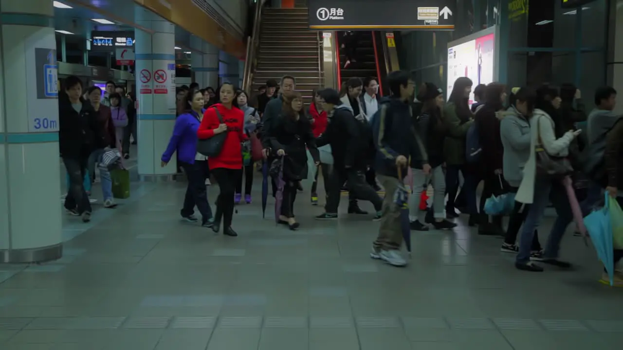 Asian flow of people changes platforms in public transport junction station