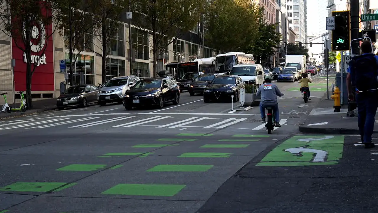 Electric bikes crossing street in Seattle Washington target shop sign in background