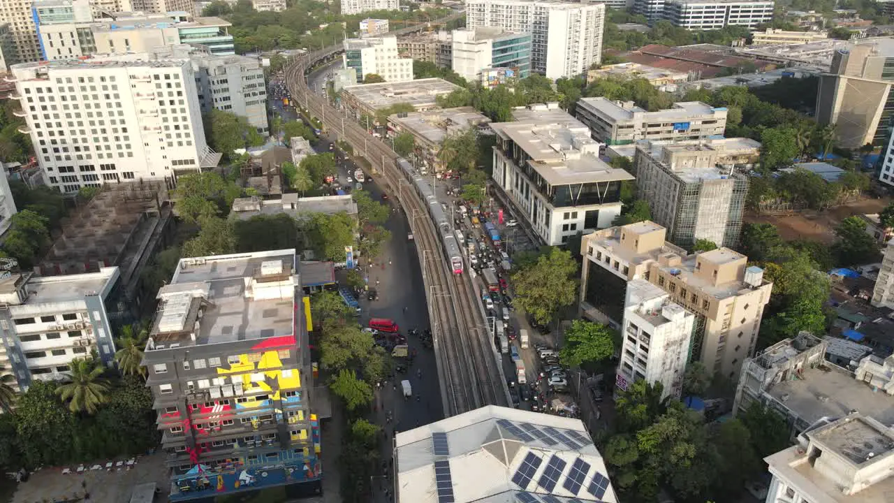 drone shot bird's-eye view and her Marol metro station Mumbai international airport Mumbai India wide-angle train coming into Andheri station