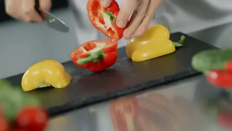 Chef cooking food at kitchen restaurant Closeup chef hands cutting red pepper