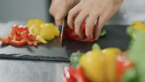 Chef cooking healthy food at kitchen restaurant Closeup hands cutting pepper