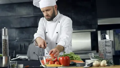 Chef cooking at restaurant kitchen Professional chef making fresh salad