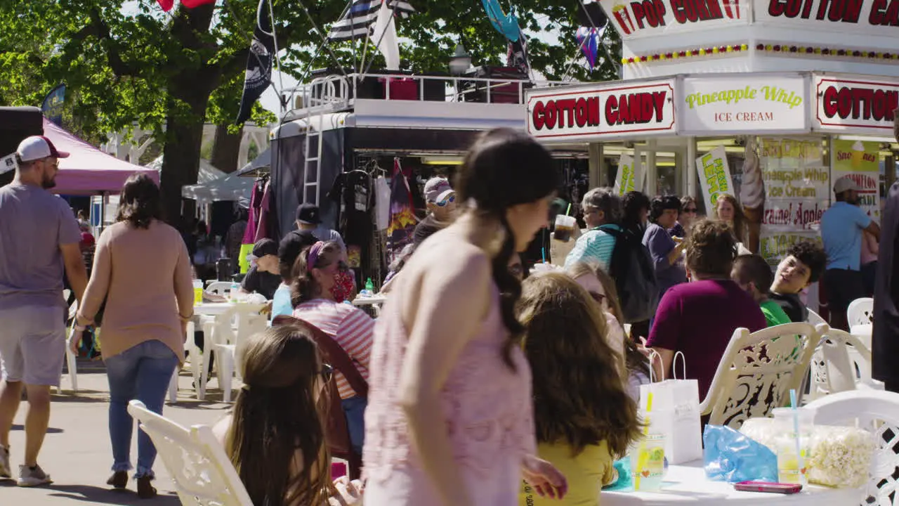 Hordes of people attending Dogwood Festival browse food stalls in Siloam Springs Arkansas