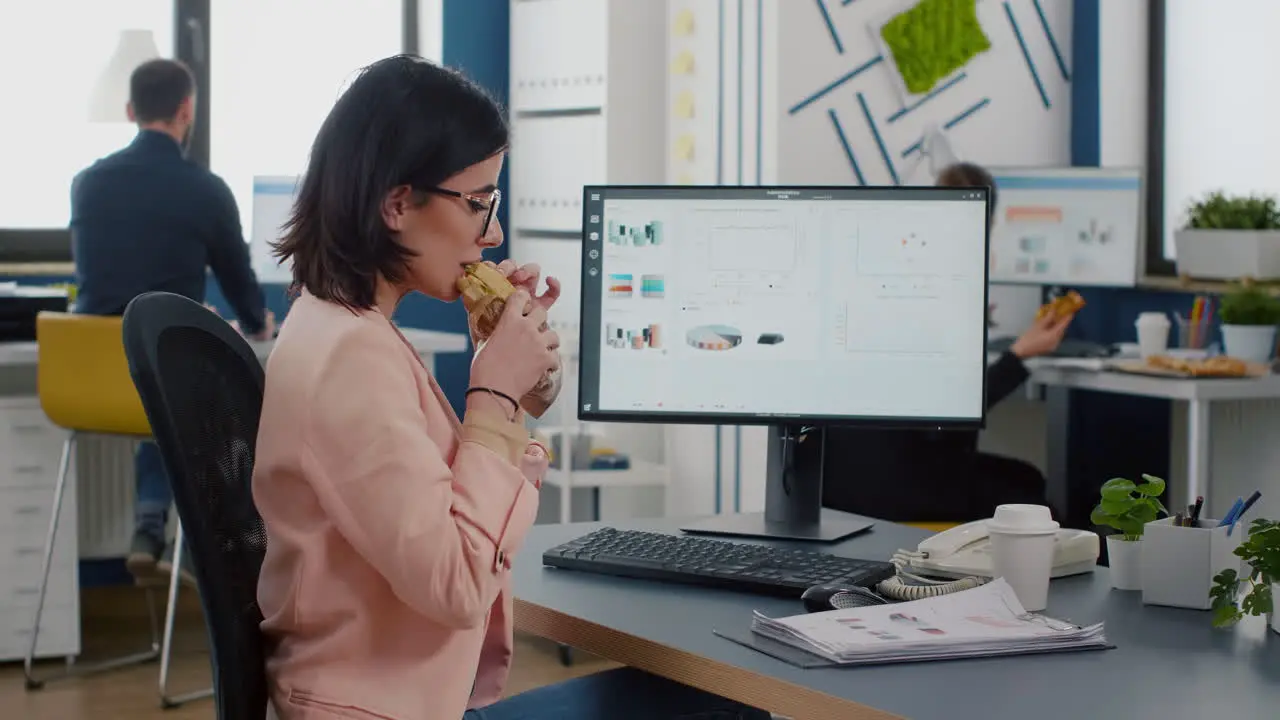 Businesswoman having delivery lunch food order during takeaway lunchtime working in business company