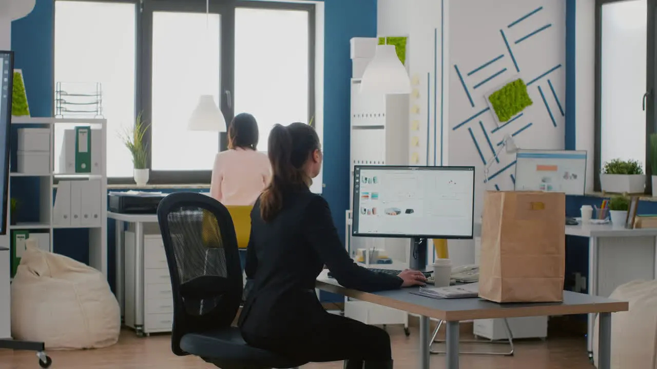 Executive manager holding takeaway food bag order during takeout lunchtime in startup business corporate