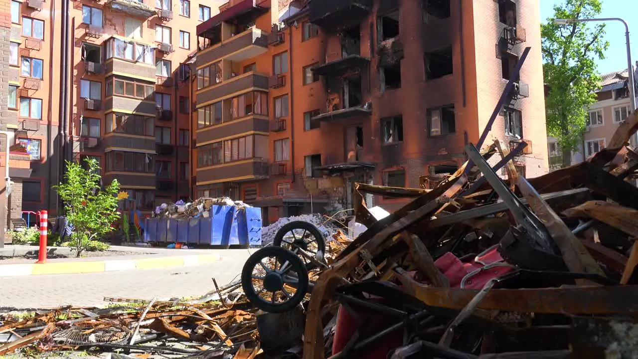 Tilt Down From A Destroyed Apartment Building In Irpin Ukraine To Baby Carriage Sitting In Rubble Following Russian Airstrikes