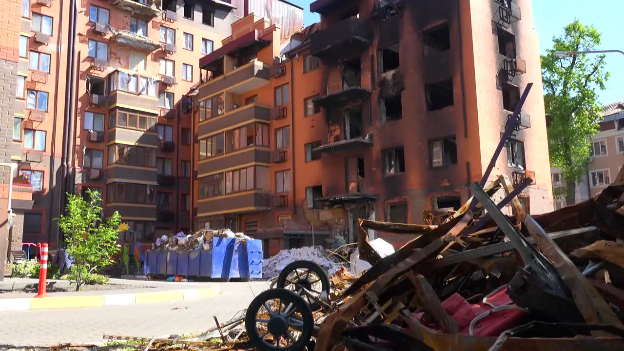 Tilt Up From A Destroyed Apartment Building In Irpin Ukraine To Baby Carriage Sitting In Rubble Following Russian Airstrikes