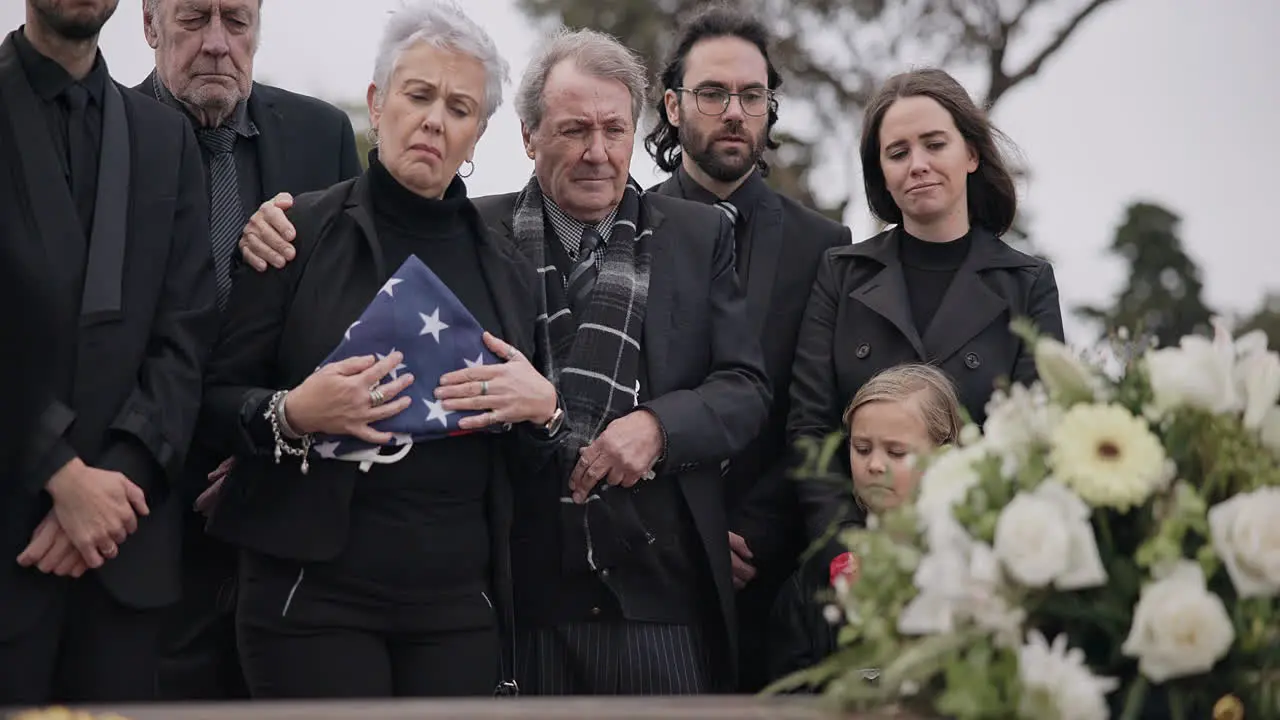 Funeral cemetery and family with American flag