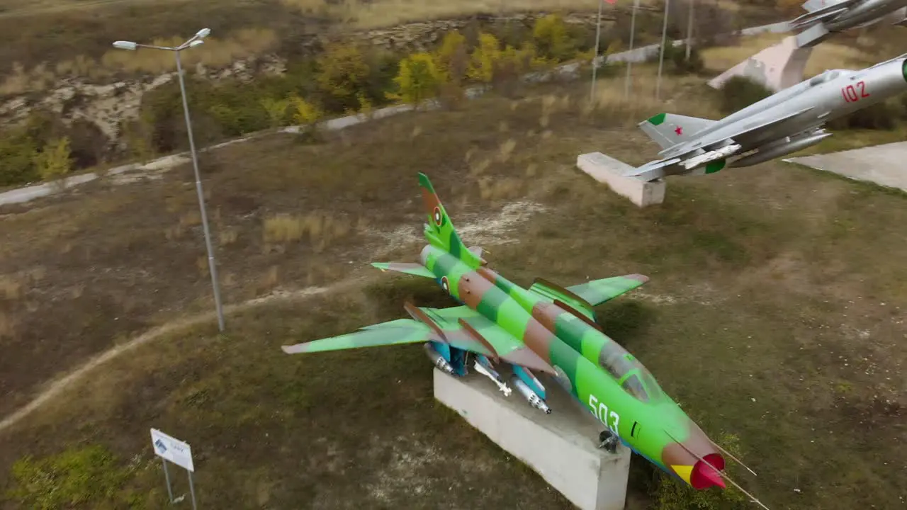 Aerial panning footage of military airplanes outdoor museum exhibition